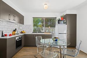 a kitchen with a glass table in a kitchen at Casa Capri - Aldinga Beach - C21 SouthCoast Holidays in Aldinga Beach