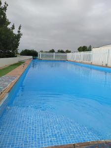 een groot zwembad met blauw water bij Family villa fantastic location in Lliria