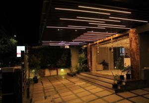 a building with a lit up courtyard at night at Hotel M Grand in Chennai
