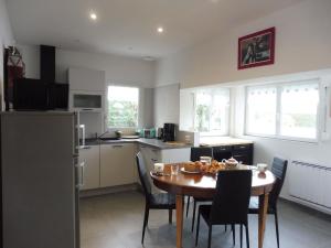 a kitchen and dining room with a table and chairs at Pretty cottage near sandy beach in the Cotentin in Gouville-sur-Mer