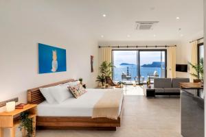 a bedroom with a bed and a living room at Born in Blue in Kaş