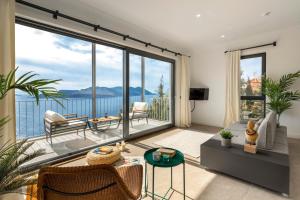 a living room with a view of the water at Born in Blue in Kaş