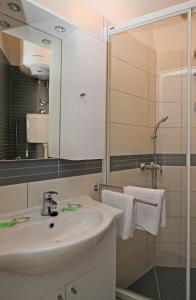 a white bathroom with a sink and a shower at Apartment Love Dubrovnik in Dubrovnik