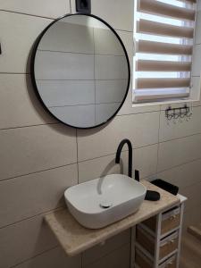 a bathroom with a white sink and a mirror at Licul Apartment in Rovinj +37 photos
