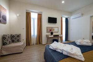 a hotel room with a bed and a couch at Kalypso Apartments in Kalamata