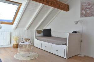 a bedroom with a bunk bed in a attic at bel appartement dans la montagne, L'orée du Bois in Mouthe