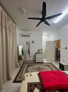 a living room with a ceiling fan and a rug at Hadeerna Homestay - Double storey terrace in Chemor
