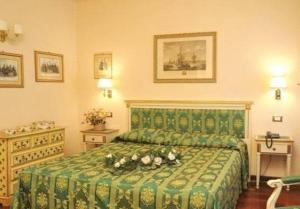 a bedroom with a green bed with flowers on it at Villa Crispi in Mestre +6 photos