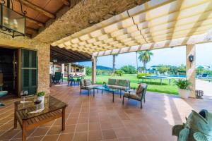 an outdoor patio with a table and chairs at Ideal Property Mallorca - Axilo - Els Mitjans in Artá