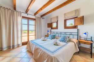 a bedroom with a bed and a window at Ideal Property Mallorca - Axilo - Els Mitjans in Artá +29 photos