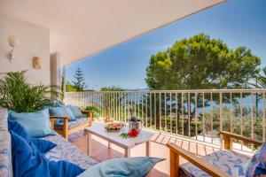 a living room with a couch and a table on a balcony at Ideal Property Mallorca - Bell Punt in Alcanada