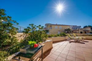 a patio with a table and chairs and the sun at Ideal Property Mallorca - Ca sa Tati in Son Serra de Marina