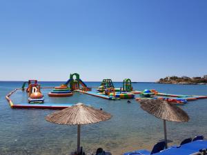 a group of inflatable rides in the water on a beach at cottage du soleil in Makry Gialos