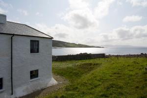 a house on the shore of a body of water at Termon House in Dungloe