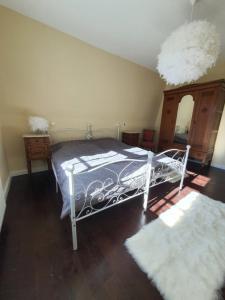 a bedroom with a white bed and two rugs at Villa Meschede in Meschede