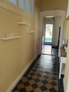 a living room with a checkered floor and a hallway at Villa Meschede in Meschede