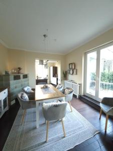 a living room with a table and some chairs at Villa Meschede in Meschede