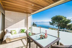 a patio with a table and chairs and a couch at Ideal Property Mallorca - Villa Alcanada 1 in Alcanada
