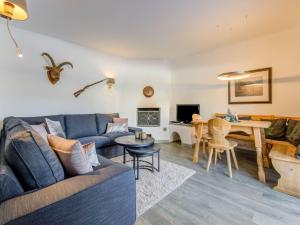 a living room with a couch and a table at Valley View Apartment near Skiing Area in Kirchberg in Tirol