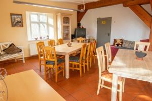 a kitchen and dining room with a table and chairs at Eulenhof 