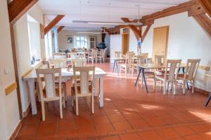 comedor con mesas y sillas de madera en Eulenhof, 