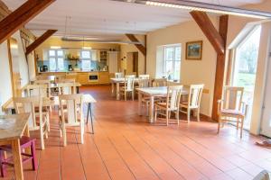 a dining room with wooden tables and chairs at Eulenhof 