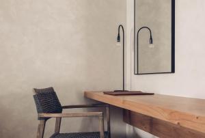a wooden desk with a chair and a mirror at Monastery Estate Retreat in Sougia