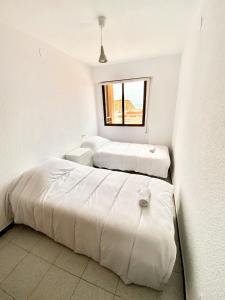 1 dormitorio con 2 camas y ventana en Apartamento Anclamar II REF 017, en Oropesa del Mar