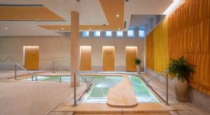 a pool in the middle of a building at Hotel Caesius Thermae & Spa Resort in Bardolino