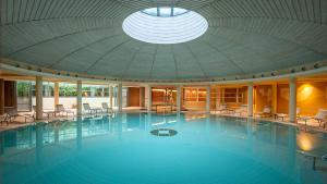 a large swimming pool in a building with a ceiling at Hotel Caesius Thermae & Spa Resort in Bardolino
