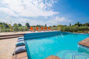 a swimming pool with chairs and a fence at Ideal Property Mallorca - Ses Comes in Selva