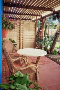 a table and chairs on a patio under a pergola at Hacienda Sajorami in Zahora