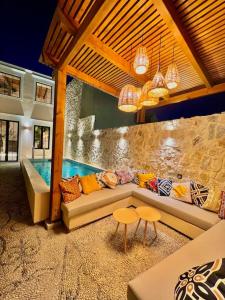a living room with a couch and a swimming pool at Katoikía Pateliá in Koskinou