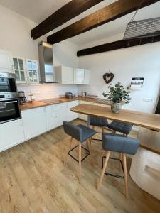 a kitchen with a wooden table and some chairs at Ferienwohnung Brückenkopf OG in Hameln