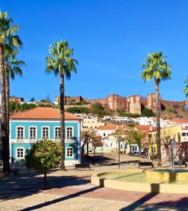 une ville avec des palmiers et un bâtiment bleu dans l'établissement La Maison Bleue Algarve, à Silves