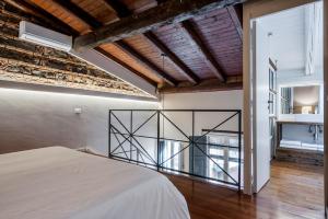 A bed or beds in a room at Ferrini Home - Piazza Trento