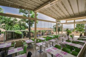 モンタニャックにあるBelambra Clubs Montpezat - Le Verdonの緑のテーブルと椅子が備わる空きレストランです。