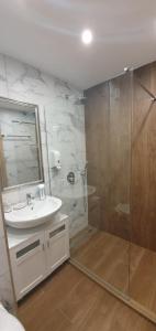 a bathroom with a sink and a shower at FOX boutique apartment Borovets Gardens in Borovets +90 photos