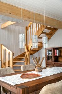 a dining room with a table and a staircase at Villa Wasserkreuz in Wandlitz