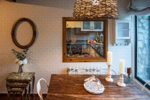 a dining room with a wooden table and a mirror at Casa rural la castañona in Buiza