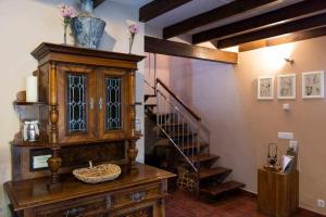 a room with a wooden cabinet and a staircase at Casa rural la castañona in Buiza