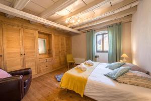 a bedroom with a large bed with two towels on it at ST-JORIOZ - C'est une maison bleue, 6pax 3 ch, LLA Selections by Location lac Annecy in Saint-Jorioz