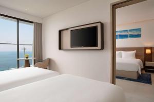 A bed or beds in a room at Radisson Hotel Danang