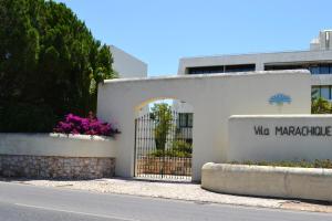 a building with a gate in front of a street at Tupi Nest in Alvor