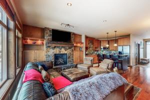 a living room with a couch and a fireplace at Southpoint #23 in Big White