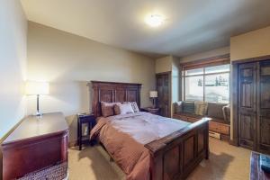 a bedroom with a large bed and a window at Southpoint #23 in Big White