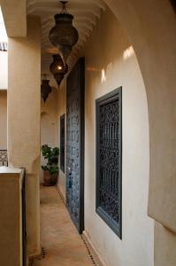 an alley with a door in a building at Riad Papillon by Marrakech Riad in Marrakesh