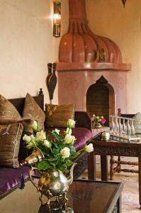 a living room with a couch and a table at Riad Papillon by Marrakech Riad in Marrakesh