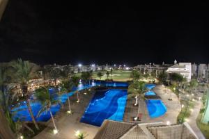 an overhead view of a pool at a resort at night at Golf Ville Resort in Beach Park in Aquiraz