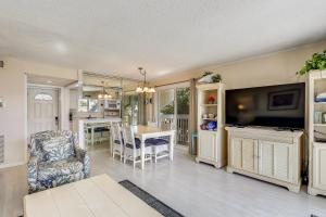 a living room with a kitchen and a dining room at Sandpiper Cove 1082 Destin Condo in Destin